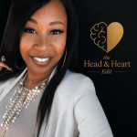 A woman with long black hair smiling, wearing a white blazer and layered necklaces, standing next to a logo with a brain and heart, on a black background.