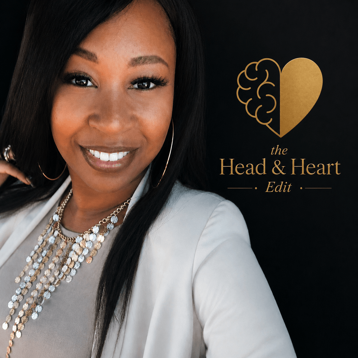 A woman with long black hair smiling, wearing a white blazer and layered necklaces, standing next to a logo with a brain and heart, on a black background.