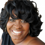 Close-up of a smiling woman with curly black hair, wearing hoop earrings, against a black background.