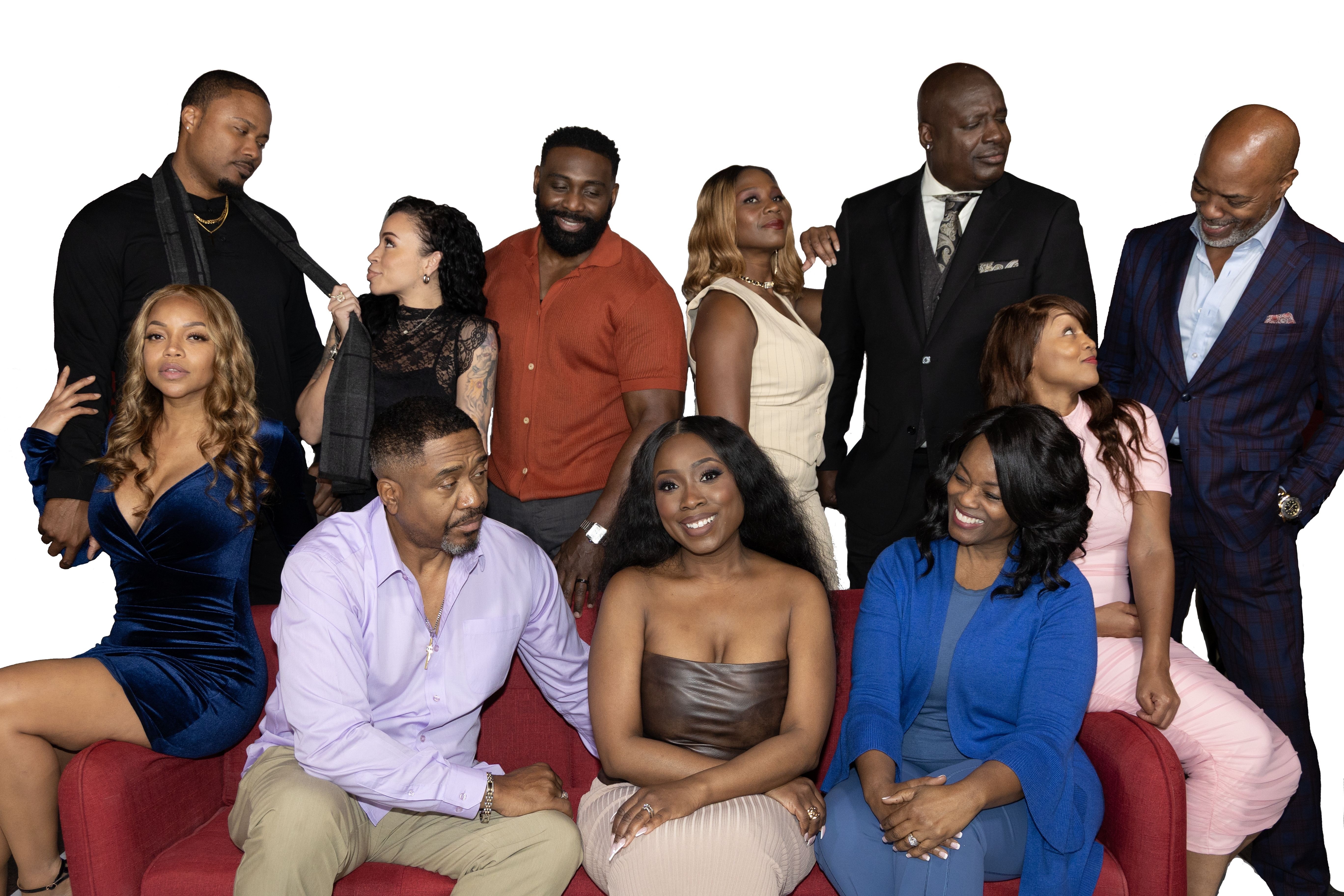 Group of ten diverse people sitting and standing, dressed in formal and casual clothing, smiling and interacting.