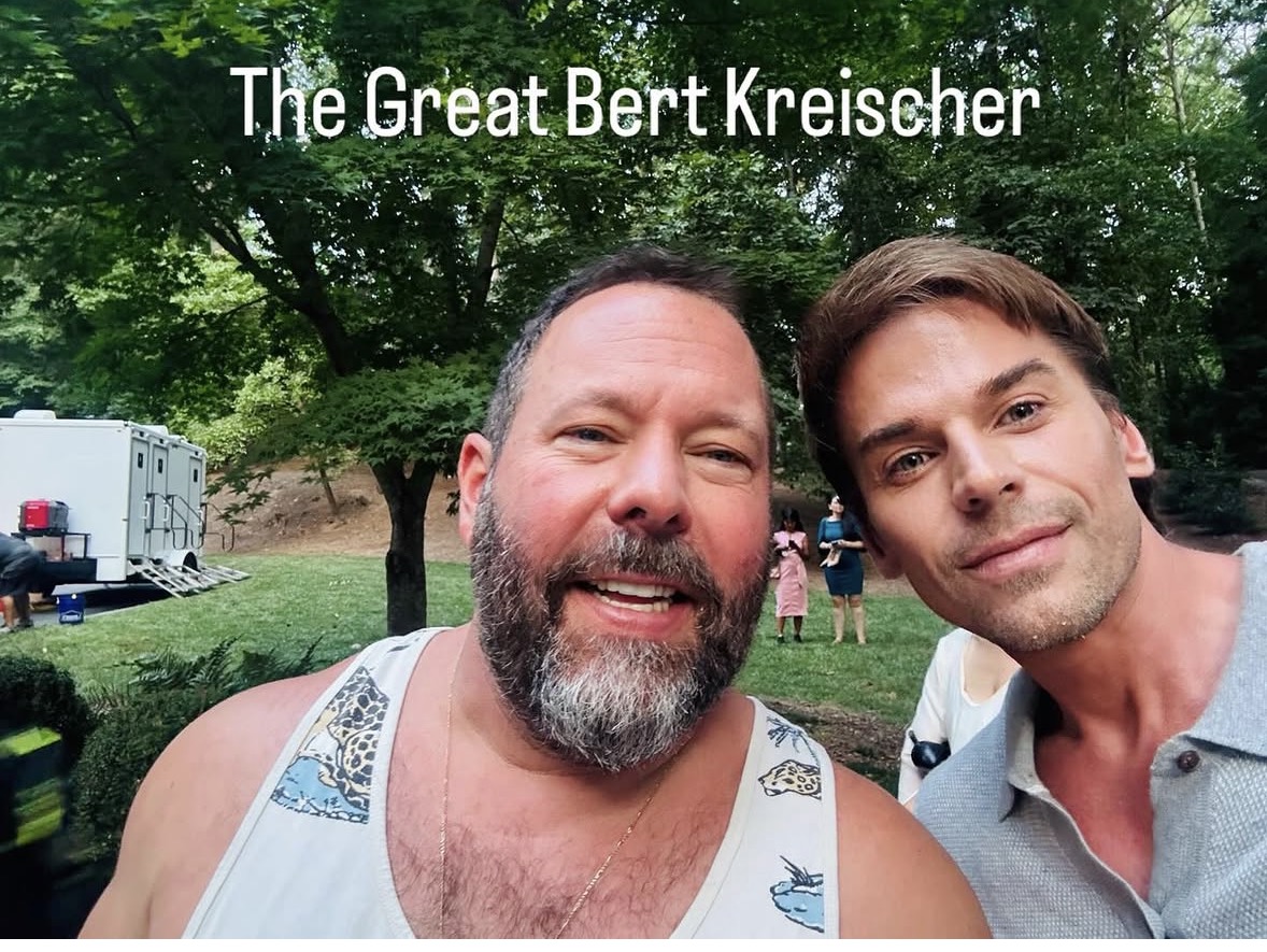 Two men outdoors with trees, smiling, with text 'The Great Bert Kreischer' above them.