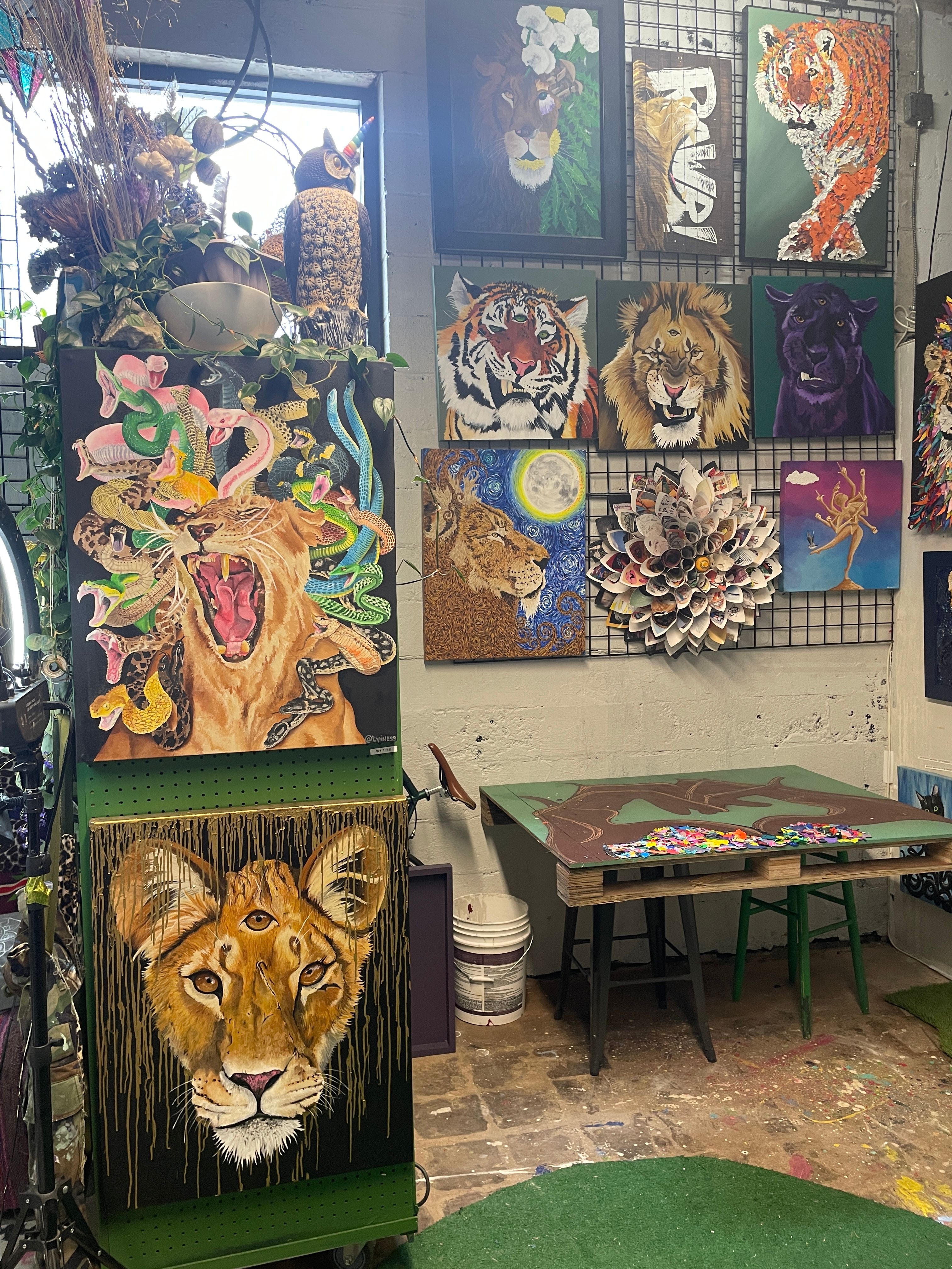 Colorful painting of flamingos and abstract shapes, with a lion's face on a green background, displayed on a chair.
