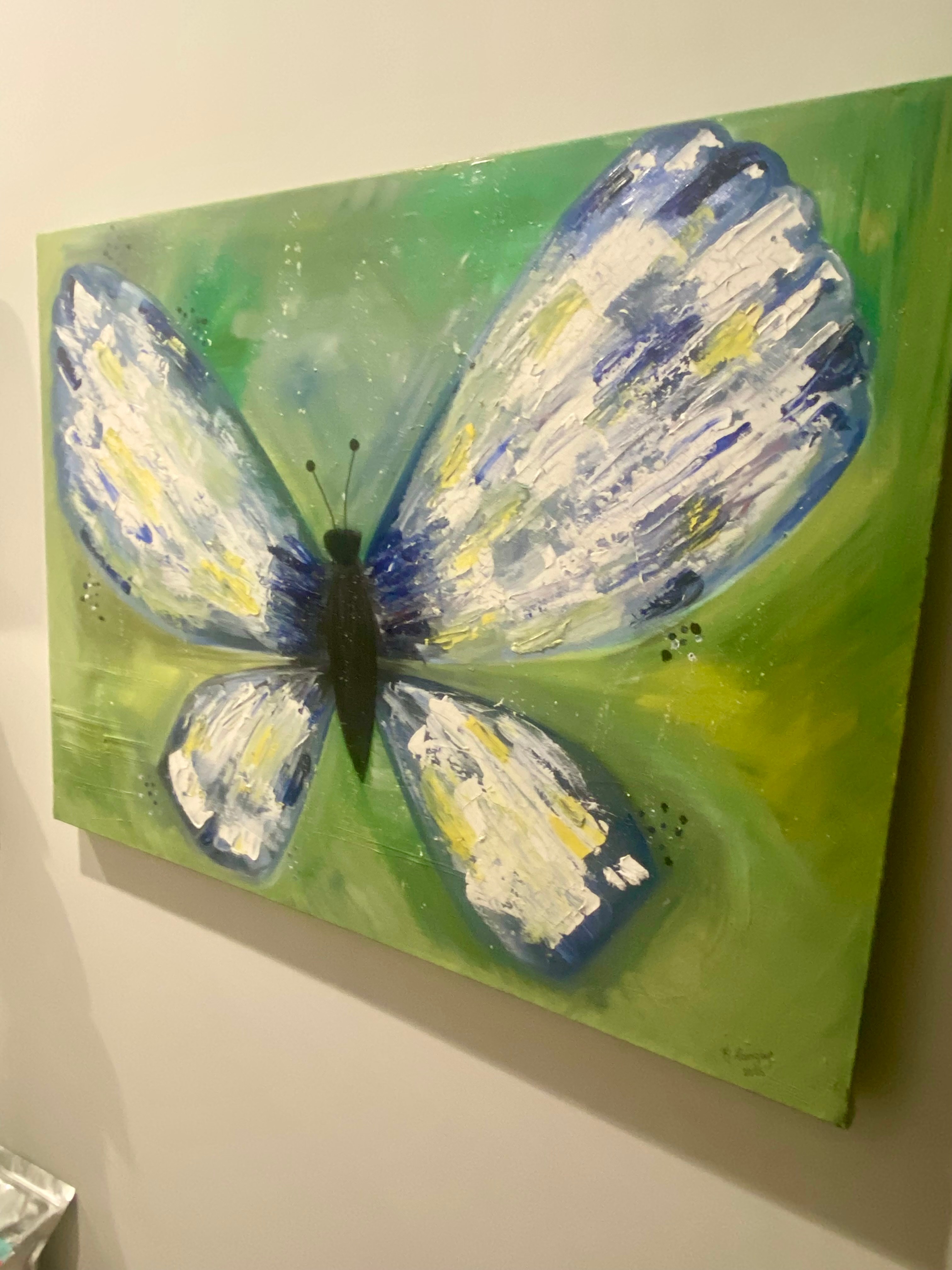 Blue and white butterfly painting on green background, with textured wings and black body, viewed from the side.