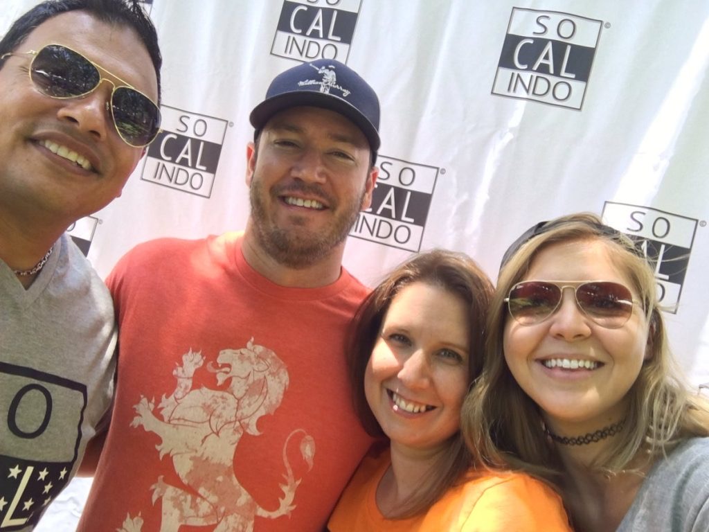 Four people smiling in front of a backdrop with 'SO CAL INDO' logos.