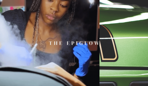 Young woman with braided hair wearing blue gloves, working with equipment, with a ring light behind her.