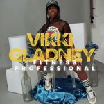 Person sitting on a white chair with a blue bag on the floor, text overlay reads 'Vikki Gladney Fitness Professional'.